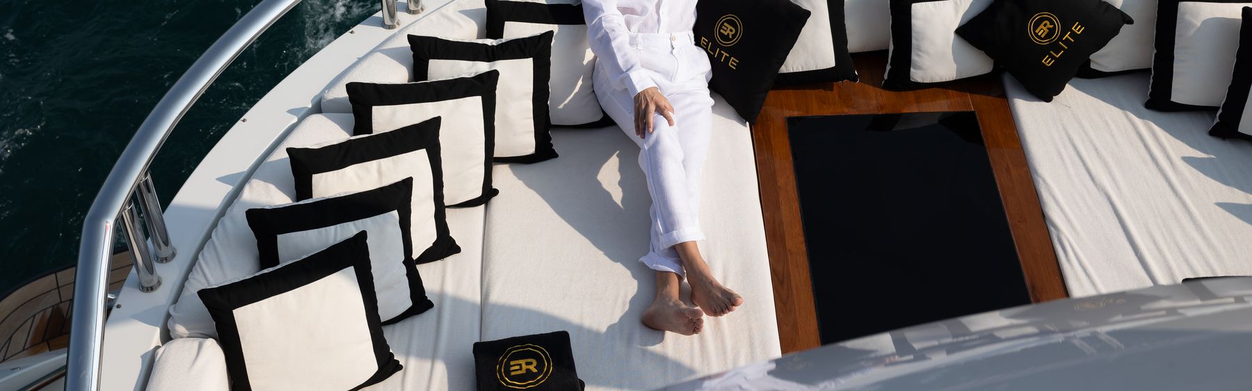 Elite Rentals branded deck cushions on the bow of a charter yacht